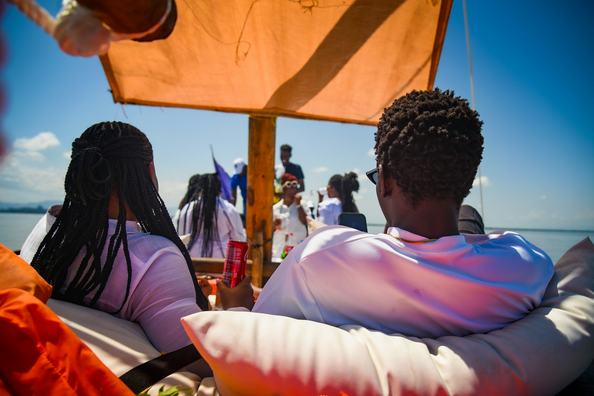 People relax on a boat enjoying the sunny weather.